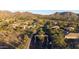 Stunning aerial view of a gated community surrounded by desert landscape with mountain views at 11496 E Pine Valley Rd, Scottsdale, AZ 85255