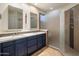 Modern bathroom featuring a double sink vanity, a walk-in shower, and sleek fixtures at 11496 E Pine Valley Rd, Scottsdale, AZ 85255