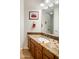 Elegant bathroom features a granite countertop, wooden cabinets and modern fixtures at 11496 E Pine Valley Rd, Scottsdale, AZ 85255