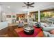 Spacious living room with hardwood floors, a ceiling fan, and a view of the backyard at 11496 E Pine Valley Rd, Scottsdale, AZ 85255