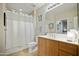 Bright bathroom featuring a shower with white curtain and a wooden vanity cabinet at 11640 N Tatum Blvd # 1052, Phoenix, AZ 85028