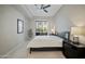 Modern bedroom with neutral walls, ceiling fan, and sliding glass doors to a balcony at 11640 N Tatum Blvd # 1052, Phoenix, AZ 85028