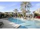 Large outdoor swimming pool surrounded by palm trees and lounge chairs at 11640 N Tatum Blvd # 1052, Phoenix, AZ 85028