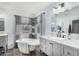 Charming bathroom featuring a clawfoot tub, marble counters, and decorative accents at 1252 N Jackson St, Gilbert, AZ 85233