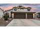 Beautiful two-story home featuring a three car garage and desert landscaping at 1252 N Jackson St, Gilbert, AZ 85233