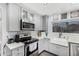 Bright kitchen featuring stainless steel appliances and modern white cabinetry at 1252 N Jackson St, Gilbert, AZ 85233