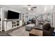 Spacious living room features leather furniture, a ceiling fan, and an open floor plan at 1252 N Jackson St, Gilbert, AZ 85233