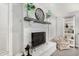 Living room showcasing a brick fireplace with decorative mantle and accent chair at 1252 N Jackson St, Gilbert, AZ 85233