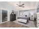 This main bedroom has wood-look tile floors, a ceiling fan, and an adjacent sitting area at 1252 N Jackson St, Gilbert, AZ 85233