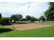 Outdoor basketball court surrounded by green grass, trees, and benches at 13070 W Eagle Talon Trl, Peoria, AZ 85383