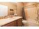 Bathroom featuring a solid surface vanity countertop, tub/shower with curtain, and tile flooring at 13070 W Eagle Talon Trl, Peoria, AZ 85383