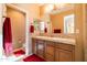 Bathroom featuring double sinks, decorative framed mirror and backsplash, and a separate toilet room at 13070 W Eagle Talon Trl, Peoria, AZ 85383