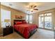 Bedroom with a private glass sliding door that opens to the covered patio and outdoor seating area at 13070 W Eagle Talon Trl, Peoria, AZ 85383