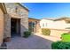 Beautifully landscaped courtyard with brick pavers, ideal for outdoor seating and entertaining at 13070 W Eagle Talon Trl, Peoria, AZ 85383