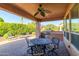 View of covered patio with ceiling fan, grill, outdoor kitchen, and seating at 13070 W Eagle Talon Trl, Peoria, AZ 85383