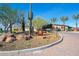 Community entrance and sign for the Mita community showcasing desert landscaping and several palm trees at 13070 W Eagle Talon Trl, Peoria, AZ 85383