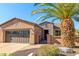 Charming single-story home featuring desert landscaping, a stone facade, and a spacious two-car garage at 13070 W Eagle Talon Trl, Peoria, AZ 85383