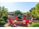 Backyard firepit area featuring circular seating, desert landscaping, and gravel at 13070 W Eagle Talon Trl, Peoria, AZ 85383