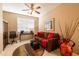 Cozy living room with neutral colors, a ceiling fan, comfortable furniture, and ample natural light at 13070 W Eagle Talon Trl, Peoria, AZ 85383