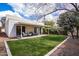 Charming backyard with covered patio, lush lawn, and mature landscaping at 1327 W Glendale Ave, Phoenix, AZ 85021