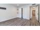 Bedroom with wood-look flooring, closet, and bright lighting at 1327 W Glendale Ave, Phoenix, AZ 85021