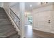 Inviting entryway showcasing wood floors, white walls, and a staircase leading to the upper level at 1327 W Glendale Ave, Phoenix, AZ 85021