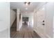 Spacious entryway with sleek gray floors flows into a modern kitchen and staircase, with a front door to the right at 1327 W Glendale Ave, Phoenix, AZ 85021