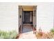 Inviting front entrance showcasing a black door, brick exterior, and gated courtyard at 1327 W Glendale Ave, Phoenix, AZ 85021