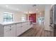 Bright kitchen island with white cabinets and countertops provides an open view to the living area at 1327 W Glendale Ave, Phoenix, AZ 85021