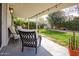 Cozy covered patio with outdoor seating, offering a relaxing view of the lush green backyard at 1327 W Glendale Ave, Phoenix, AZ 85021