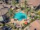 Resort-style pool area from above, featuring palm trees, lounge seating, spa, and shade structures at 14250 W Wigwam Blvd # 1022, Litchfield Park, AZ 85340