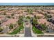 Aerial view of a well-maintained community featuring beautiful landscaping and similar style houses with red tile roofs at 14250 W Wigwam Blvd # 1022, Litchfield Park, AZ 85340