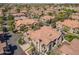 Aerial view of several community homes in a well-maintained neighborhood with manicured lawns and mature trees at 14250 W Wigwam Blvd # 1022, Litchfield Park, AZ 85340