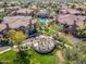 Overhead view of pool, surrounding landscaping, and community seating area with matching residential properties at 14250 W Wigwam Blvd # 1022, Litchfield Park, AZ 85340