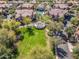 Aerial view showcases pool and green space with walking paths amongst similarly styled homes with terracotta roofs at 14250 W Wigwam Blvd # 1022, Litchfield Park, AZ 85340