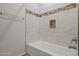 Modern bathroom featuring tiled walls, a tiled shower niche, and updated fixtures at 14250 W Wigwam Blvd # 1022, Litchfield Park, AZ 85340