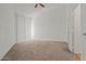 Spacious bedroom featuring a ceiling fan and vertical blinds on a large window at 14250 W Wigwam Blvd # 1022, Litchfield Park, AZ 85340