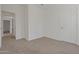 Well-lit bedroom with neutral carpet and a door leading to the hallway at 14250 W Wigwam Blvd # 1022, Litchfield Park, AZ 85340