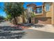 Exterior of a charming two-story home with a private garage and well-maintained landscaping at 14250 W Wigwam Blvd # 1022, Litchfield Park, AZ 85340