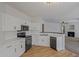 Well-lit kitchen with stainless steel appliances and sleek countertops and view to the living room at 14250 W Wigwam Blvd # 1022, Litchfield Park, AZ 85340