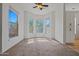 Bright, carpeted living room featuring a ceiling fan, light walls, and bay window with natural light at 14250 W Wigwam Blvd # 1022, Litchfield Park, AZ 85340