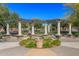 Community pergola area boasts lush landscaping, symmetrical design, and shady seating at 14250 W Wigwam Blvd # 1022, Litchfield Park, AZ 85340