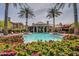 Beautiful community pool and clubhouse surrounded by palm trees and lush landscaping, perfect for relaxation and entertainment at 14250 W Wigwam Blvd # 1022, Litchfield Park, AZ 85340