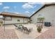 Relaxing backyard patio with comfortable seating and a low-maintenance landscape design at 14458 W Powderhorn Dr, Surprise, AZ 85374