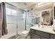 Well-lit bathroom featuring modern vanity, shower, and neutral decor, creating a refreshing space at 14458 W Powderhorn Dr, Surprise, AZ 85374