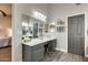 Bathroom vanity with a well-lit makeup area and storage cabinets at 14458 W Powderhorn Dr, Surprise, AZ 85374