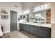 Bathroom with dual sinks, gray cabinets, and spacious countertop space at 14458 W Powderhorn Dr, Surprise, AZ 85374