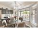 Cozy breakfast nook features a bay window and view of the patio, next to kitchen with gray cabinets and appliances at 14458 W Powderhorn Dr, Surprise, AZ 85374