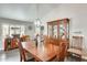 Elegant dining area boasts a stylish chandelier, ample lighting, and a traditional hutch for storage at 14458 W Powderhorn Dr, Surprise, AZ 85374