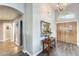 Inviting entryway features wood flooring, neutral walls, and an attractive chandelier, setting a welcoming tone at 14458 W Powderhorn Dr, Surprise, AZ 85374